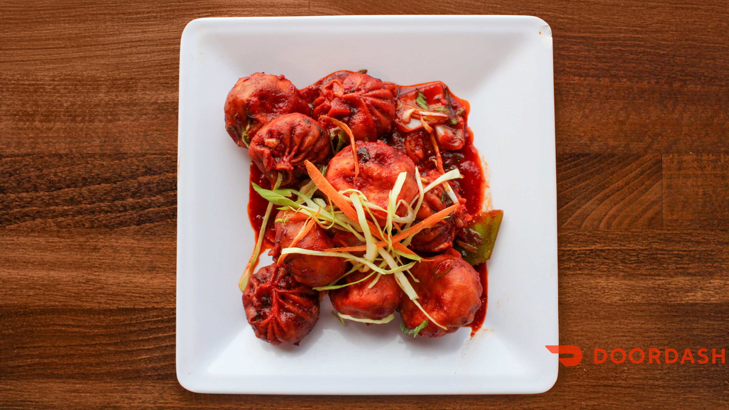 Chilli momos in spicy red sauce